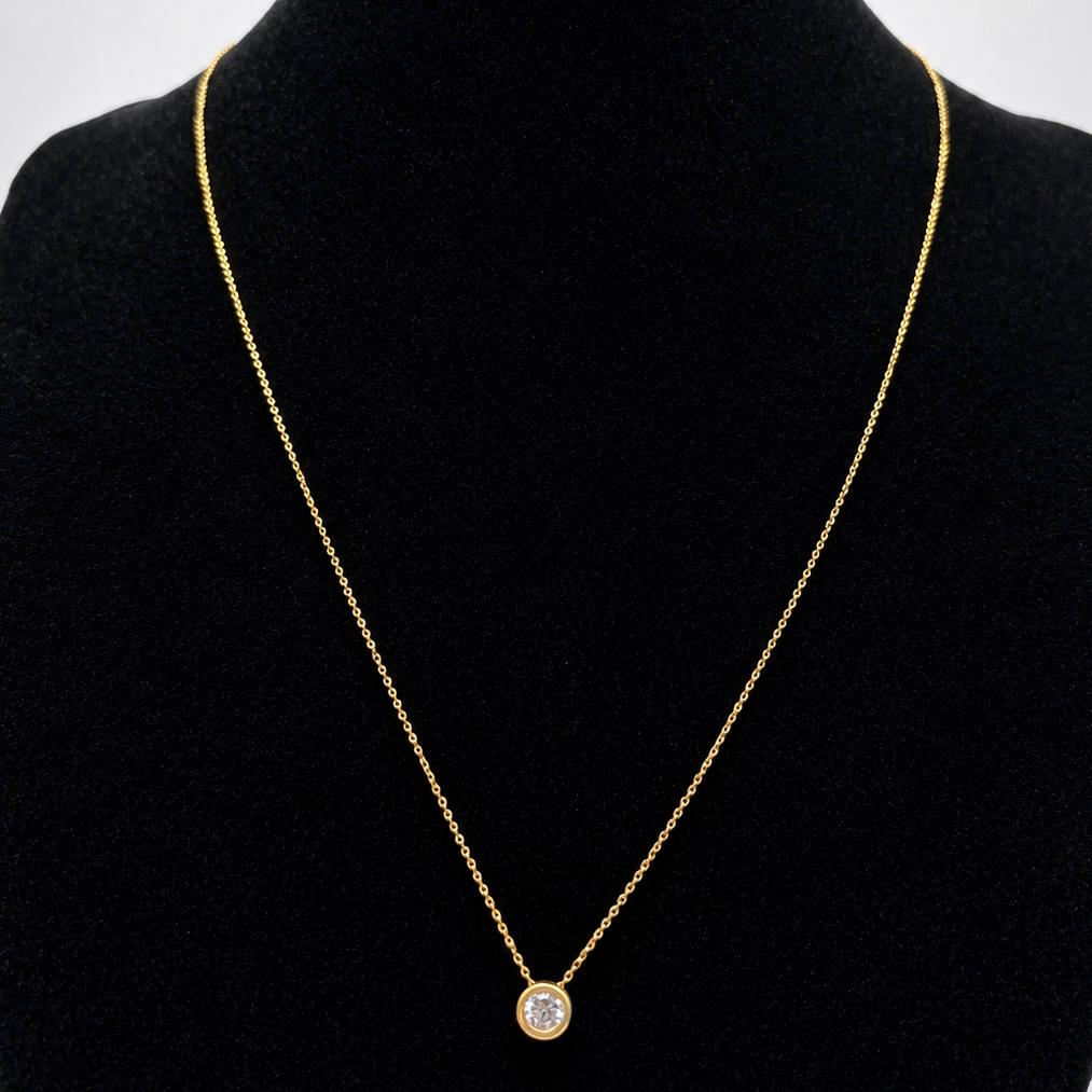 CONJUNTO EN ORO 18K CON PUNTO DE LUZ Y AROS